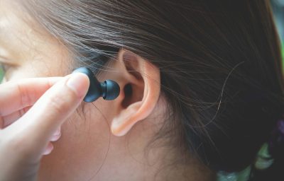 woman putting on earbuds