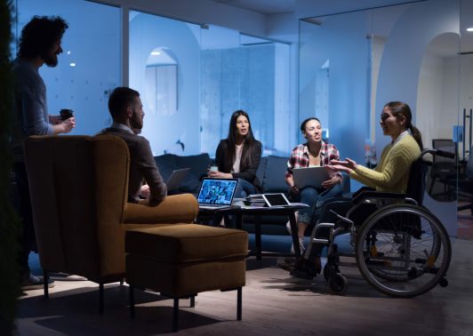 Businesswoman in wheelchair having business meeting with team at office