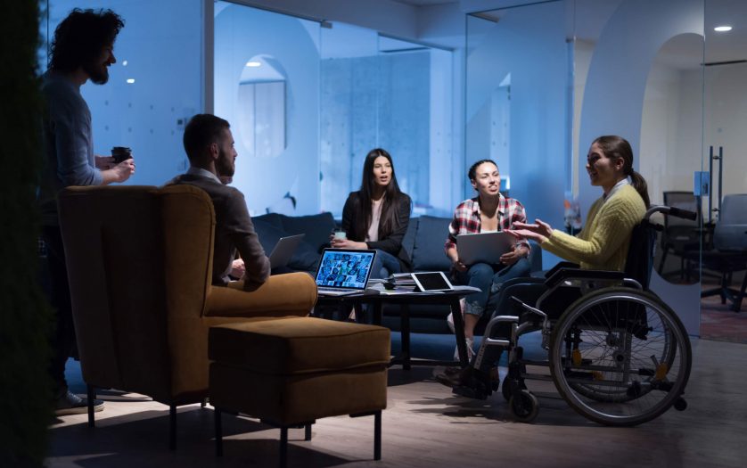 Businesswoman in wheelchair having business meeting with team at office