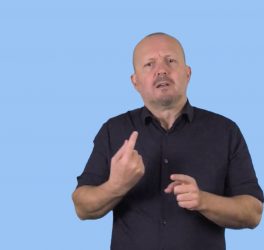 man using sign language on light blue background