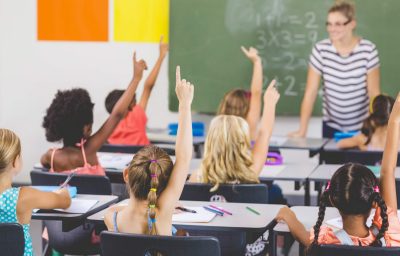 student Raising Hand in School