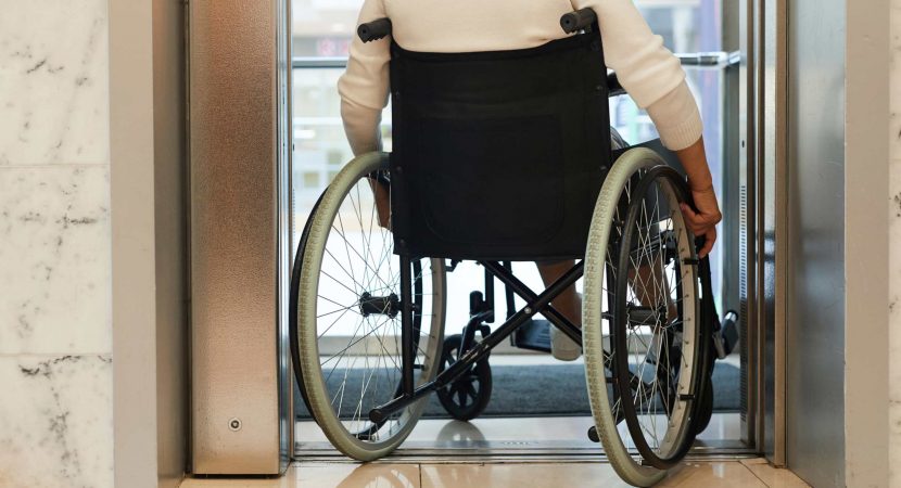 woman in wheelchair entering the elevator