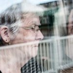 woman looking out through a window