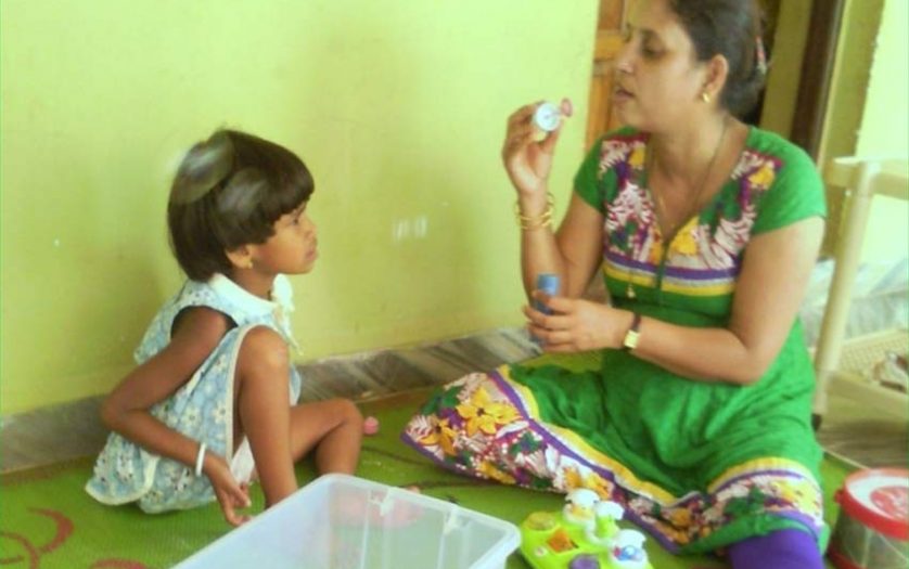 Indian woman with kid with disabilities at Autism Centre