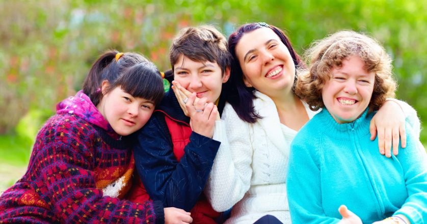 group of happy women with disability having fun in spring park