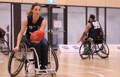 woman in wheelchair playing AFL