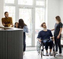 Nurse talking with patient in wheelchair