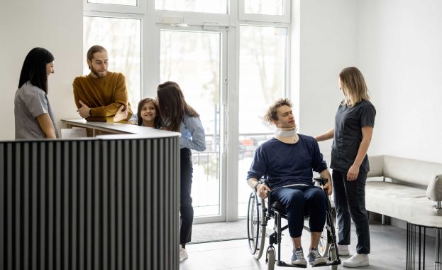 Nurse talking with patient in wheelchair