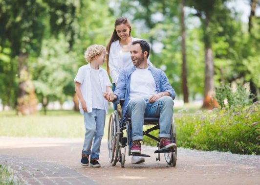 Wheelchair user with his son and wife in the street