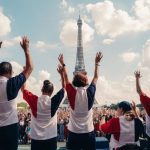 People wearing the colours of the French flag wave in front of the Eiffel tower in Paris.