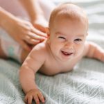 Massage therapist working with cute baby