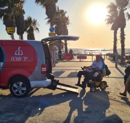 Ilan Mizrahi takes Yad Sarah's wheelchair accessible transportation service to the beach in Bat Yam, Israel