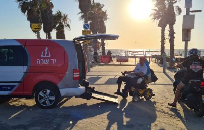 Ilan Mizrahi takes Yad Sarah's wheelchair accessible transportation service to the beach in Bat Yam, Israel