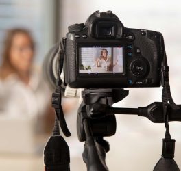 Video camera with young female blogger