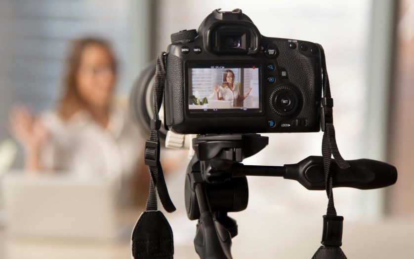 Video camera with young female blogger