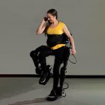 woman testing XoMotion exoskeleton