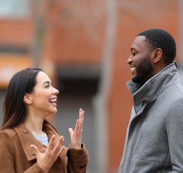 man and woman laughing and looking each other