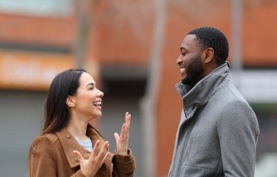 man and woman laughing and looking each other
