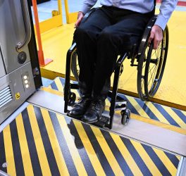 A man in a wheelchair entering accessible coach