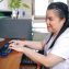 woman with vision disabilities using computer with refreshable braille display