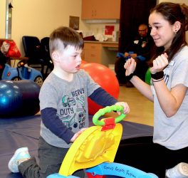 URI Nursing student Emily Nichols works with four-year-old Asher during a respite care program on campus.