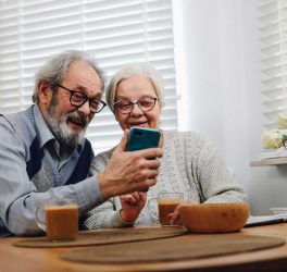 old couple looking at a phone
