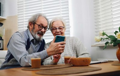 old couple looking at a phone