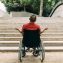 Man in wheelchair in front of the stairs