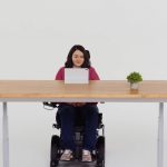 Woman in wheelchair using iPad