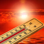 thermometer against sunset