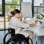 woman in wheelchair working in an office