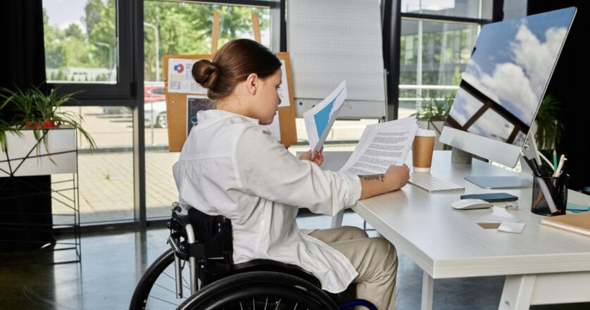 woman in wheelchair working in an office