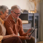Older Couple Smiling While Looking at a Tablet Computer