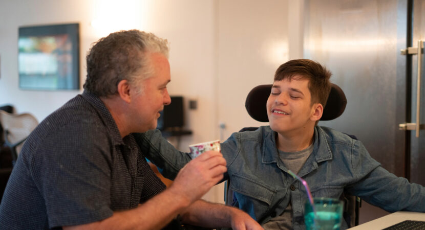 man in a wheelchair talking with carer