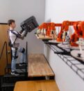 A student demonstrates how a robotic exoskeleton allows for strong movement