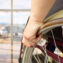 rear view of a man in wheelchair at the airport with focus on hand