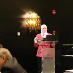a woman giving a speech on a podium