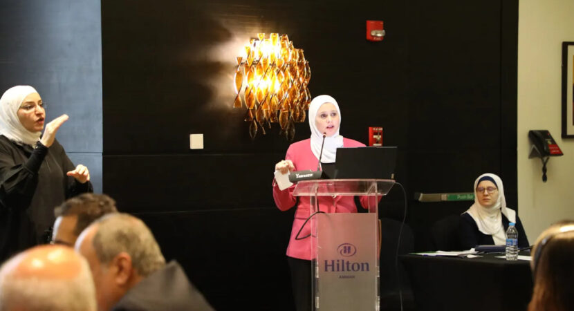 a woman giving a speech on a podium