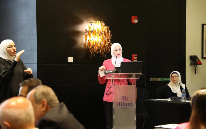 a woman giving a speech on a podium