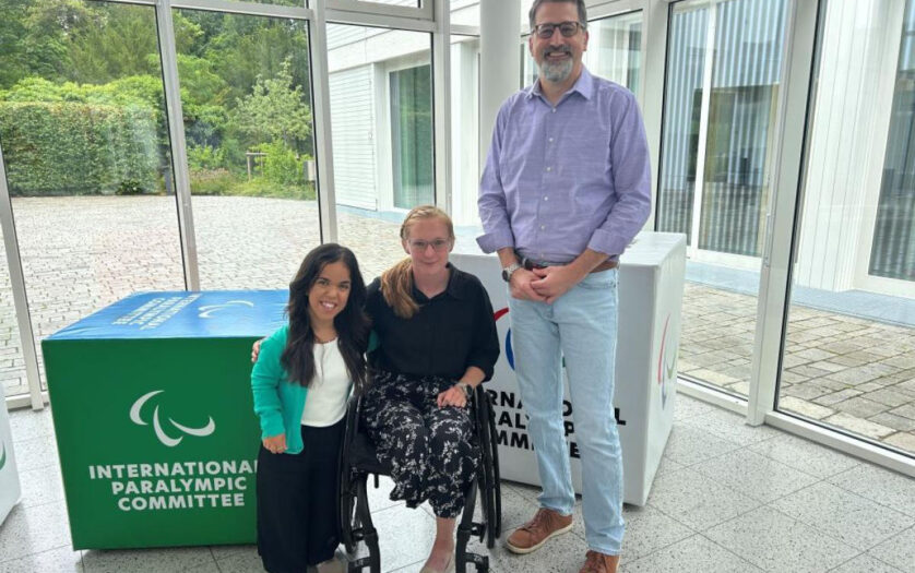 Two female Para athletes and IPC CEO Mike Peters pose for a photo at the IPC headquarters