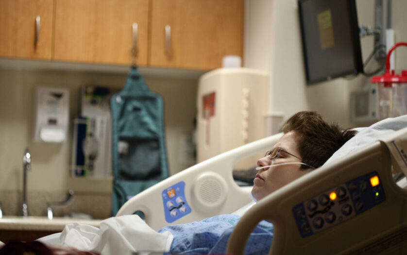 boy lying on beige recliner hospital bed