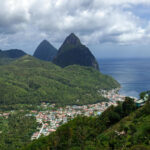 Wide Shot of City Surrounded by Green Mountains
