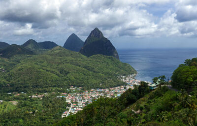 Wide Shot of City Surrounded by Green Mountains
