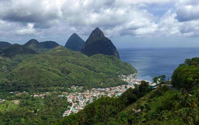 Wide Shot of City Surrounded by Green Mountains