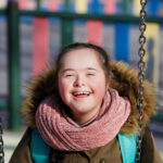 Girl with a disability enjoying swinging