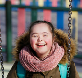 Girl with a disability enjoying swinging