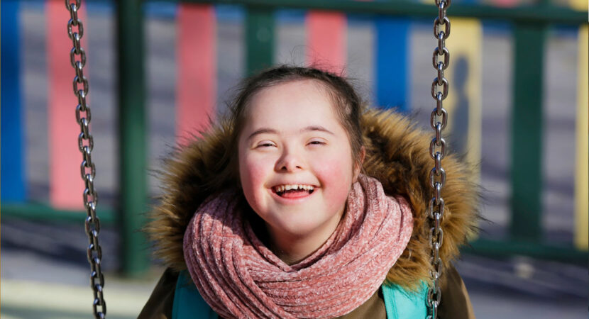 Girl with a disability enjoying swinging