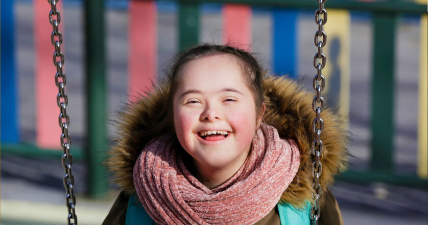 Girl with a disability enjoying swinging
