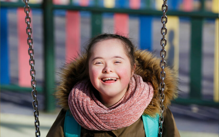 Girl with a disability enjoying swinging