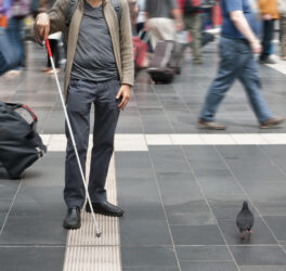 blind man with walking stick in the street